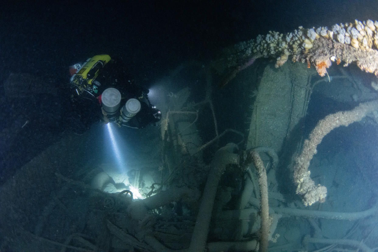 Diver Dom Robinson, part of the Dark Star diving team, which found the vessel, lights up the silt over the wreck. (SWNS)