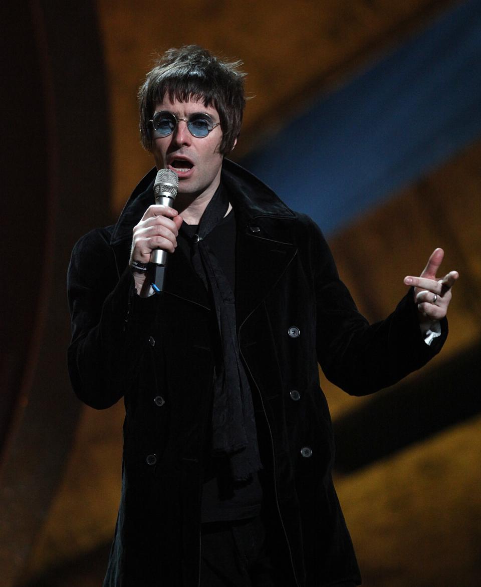 Liam Gallagher on stage to collect the award for 'BRIT's Album of 30 Years' won by Oasis during the BRIT Awards 2010, at Earls Court, London.