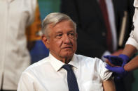 Mexican President Andres Manuel Lopez Obrador sits still moments after a nurse gave him a shot of the AstraZeneca vaccine for COVID-19 during his daily, morning news conference at the presidential palace in Mexico City, Tuesday, April 20, 2021. (AP Photo/Fernando Llano)