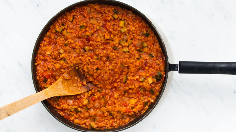 Tomatoey lentils and veg in frying pan