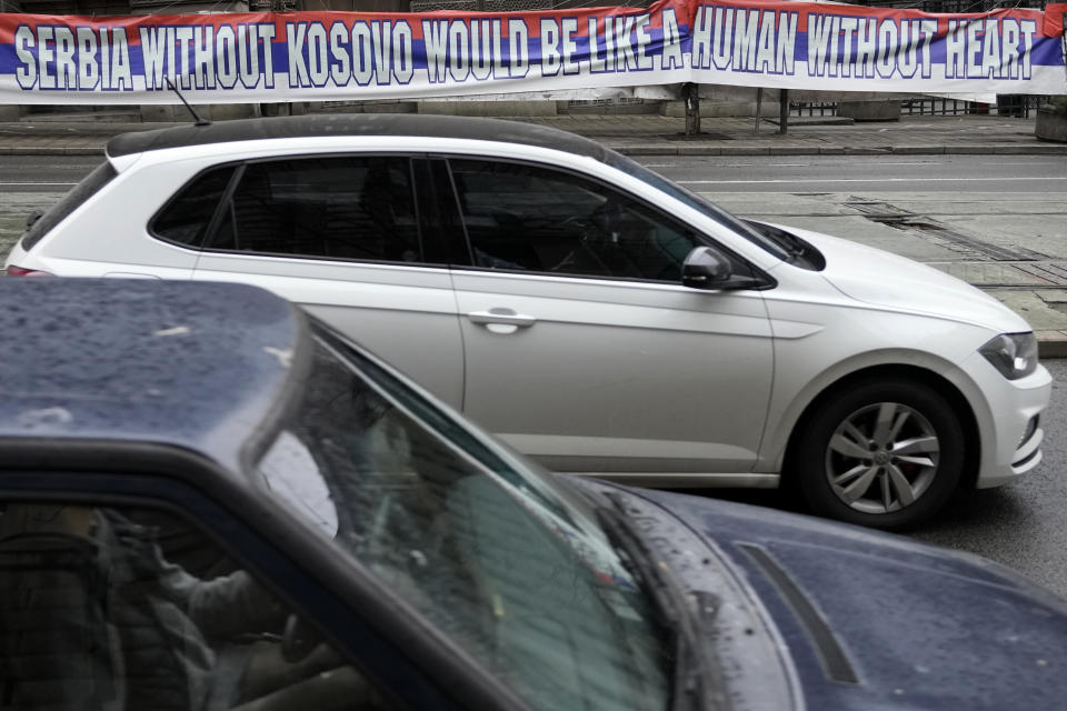 FILE - A car passes by a billboard reading: ''Serbia without Kosovo would be like a human without heart'', placed on a street in front of the government building in Belgrade, Serbia, Saturday, Feb. 25, 2023. The leaders of Serbia and Kosovo are holding talks Monday on European Union proposals aimed at ending a long series of political crises and setting the two on the path to better relations and ultimately mutual recognition. (AP Photo/Darko Vojinovic)