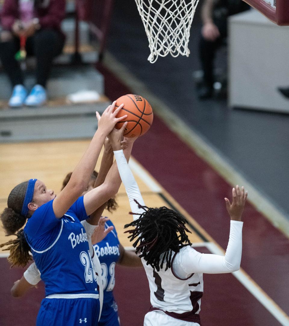 Chamiah Francis (25) and Terriyah Long (1) fight for a rebound during the Booker T. Washington vs Pensacola girls basketball game at Pensacola High School on Friday, Jan. 20, 2023.