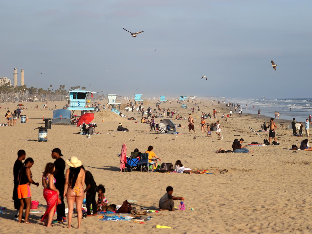 People gather at the beach on April 30, 2020 in Huntington Beach, California. California Gov. Gavin Newsom orders all beaches in state to close after today to help decrease the spread of the Coronavirus. (Michael Heiman:Getty Images)