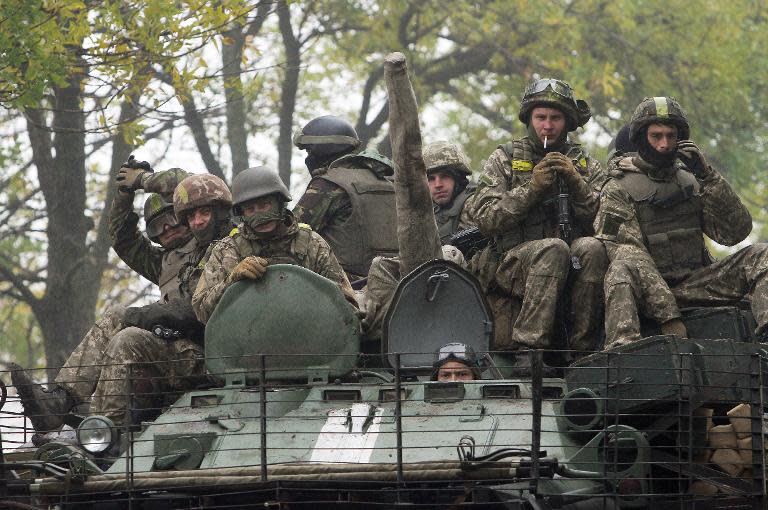 Ukrainian servicemen patrol in an armored personnel carrier in the Donetsk region on September 26, 2014. The Shakhtar football team want to return home