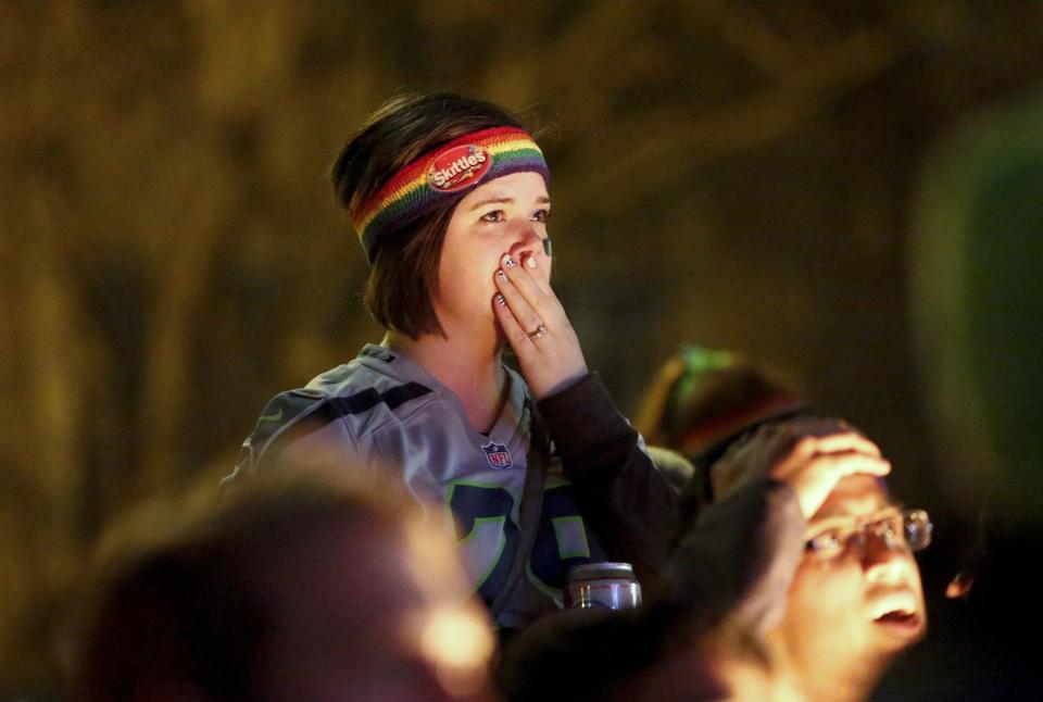 Seattle Seahawks fans react after their team lost the Super Bowl XLIX to the New England Patriots, in Seattle, Washington February 1, 2015. The New England Patriots beat the Seahawks 28-24 to win the NFL championship, Sunday in Glendale, Arizona. REUTERS/Jason Redmond (UNITED STATES - Tags: SPORT FOOTBALL)