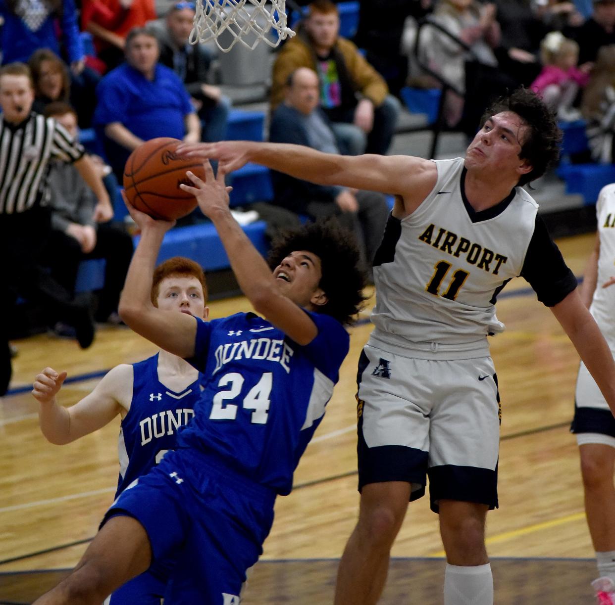 Braiden Whitaker of Dundee goes hard to the hoop but was defended by Copper Nye of Airport Thursday in the Division 2 District semifinals at Dundee.