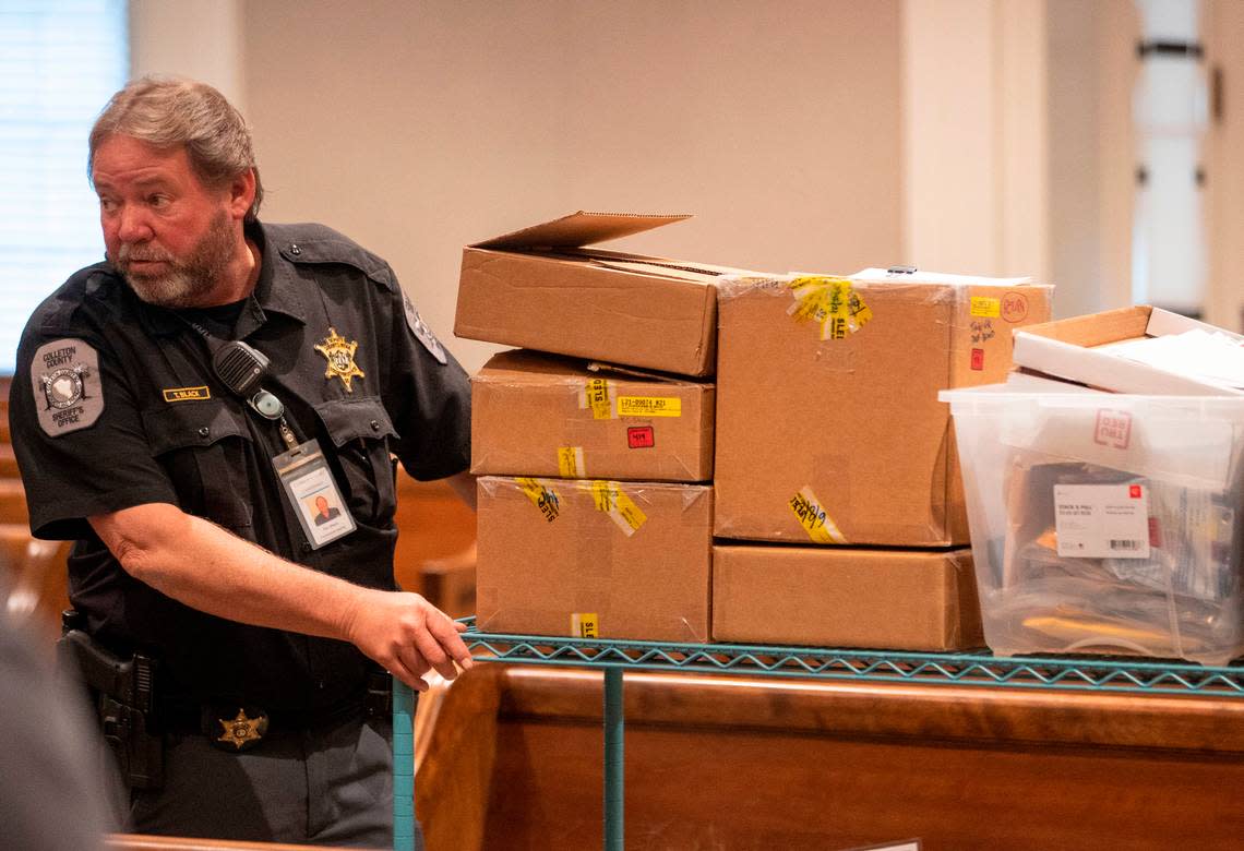 Courthouse deputy Tim Black carries off the evidence to the jury room for deliberation during the murder trial of Alex Murdaugh at the Colleton County Courthouse in Walterboro on Thursday, March 2, 2023. Andrew J. Whitaker/The Post and Courier/Pool