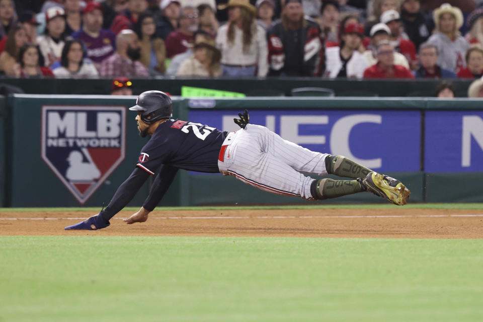 Minnesota Twins designated hitter Byron Buxton (25) slides safely into third base on a single by Kyle Farmer during the fourth inning of a baseball game against the Los Angeles Angels in Anaheim, Calif., Saturday, May 20, 2023. (AP Photo/Jessie Alcheh)