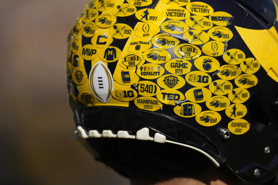 Michigan running back Blake Corum's helmet is covered with stickers as he warms up before the Rose Bowl CFP NCAA semifinal college football game against Alabama, Monday, Jan. 1, 2024, in Pasadena, Calif. (AP Photo/Mark J. Terrill)