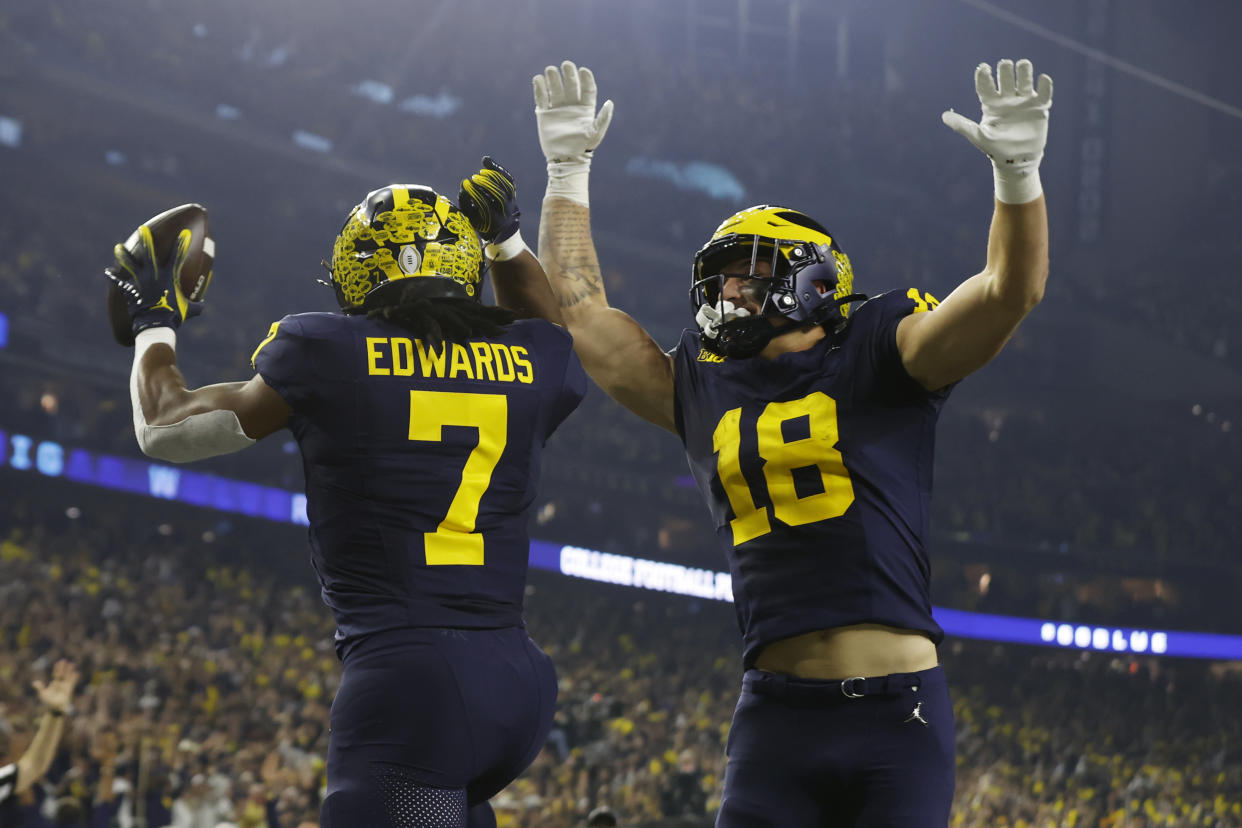 HOUSTON, TEXAS - JANUARY 8: Michigan Wolverines running back Donovan Edwards #7 celebrates his touchdown with tight end Colston Loveland #18 in the first quarter against the Washington Huskies during the 2024 CFP National Championship game at NRG Stadium on January 8, 2024 in Houston, Texas. (Photo by CFP/Getty Images)