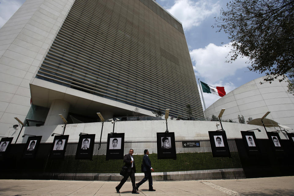 FILE - This Sept. 26, 2018 file photo shows the Senate building in Mexico City. Mexico's Senate has voted on Wednesday, June 19, 2019 to ratify a new free trade agreement with the United States and Canada, making it the first of the three countries to gain legislative approval. Hanging on the fence are the teachers college students who disappeared on Sept. 26, 2014. (AP Photo/Rebecca Blackwell, File)