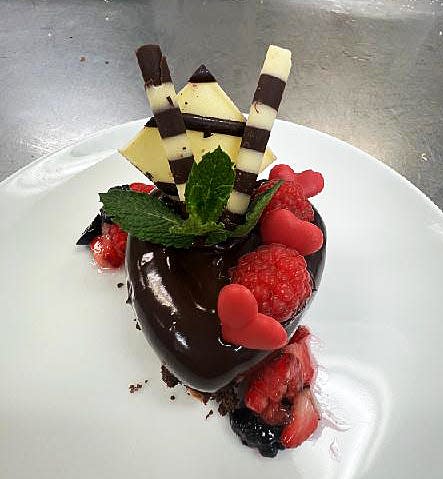 The Valentine's Day dessert at Renato's, an almond-chocolate decadent delight ($18), features a raspberry-accented triple-chocolate cake covered in chocolate ganache. 'It combines so many flavors and textures symbolizing the complexity of love,' pastry chef Vesna Capric says.
