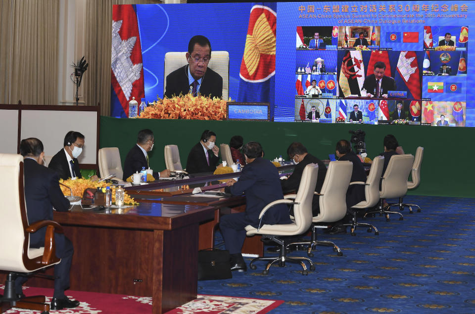 In this photo provided by the An Khoun Sam Aun/National Television of Cambodia, Cambodian Prime Minister, upper, joins an online meeting of the ASEAN-China special summit at Peace Palace in Phnom Penh, Cambodia, Monday, Nov. 22, 2021. Despite regional frictions, Chinese leader Xi Jinping says his country will not seek dominance over Southeast Asia or bully its smaller neighbors. Xi made the remarks Monday during a virtual conference with the 10 members of the Association of Southeast Asian Nations, known as ASEAN, marking the 30th anniversary of relations between the sides. (An Khoun SamAun/National Television of Cambodia via AP)