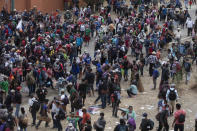 Honduran migrants are blocked by Guatemalan soldiers and police from advancing toward the US border, on the highway in Vado Hondo, Guatemala, Monday, Jan. 18, 2021. The roadblock was strategically placed at a chokepoint on the two-lane highway flanked by a tall mountainside and a wall leaving the migrants with few options. (AP Photo/Sandra Sebastian)