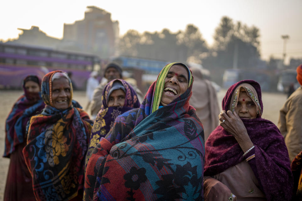 Indian pilgrims who have embarked on a visit to the sacred Pashupatinath temple react to being photographed in Kathmandu, Nepal, Jan. 9, 2024. The centuries-old temple is one of the most important pilgrimage sites in Asia for Hindus. Nepal and India are the world’s two Hindu-majority nations and share a strong religious affinity. Every year, millions of Nepalese and Indians visit Hindu shrines in both countries to pray for success and the well-being of their loved ones. (AP Photo/Niranjan Shrestha)