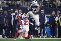 Dallas Cowboys tight end Jake Ferguson (87) leaps over New York Giants cornerback Jason Pinnock (27) during the second half of an NFL football game Thursday, Nov. 24, 2022, in Arlington, Texas. (AP Photo/Tony Gutierrez)