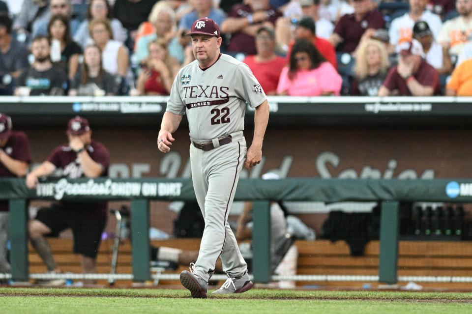 Texas A&M coach Jim Schlossnagle walks to the mound during the fifth inning of Game 2 of the CWS championship series against Tennessee. The Aggies won the first game, but then dropped the last two as the Vols won the title.