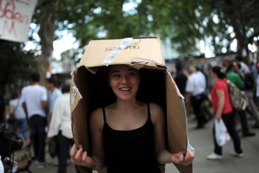 An anti-government protester shelters from the rain at Taksim Gezi park in Istanbul on June 13, 2013. Turkish Prime Minister Recep Tayyip Erdogan on Thursday issued a "last warning" for thousands of protesters to evacuate an Istanbul park at the centre of mass anti-government demos, ratcheting up tensions in two weeks of deadly unrest