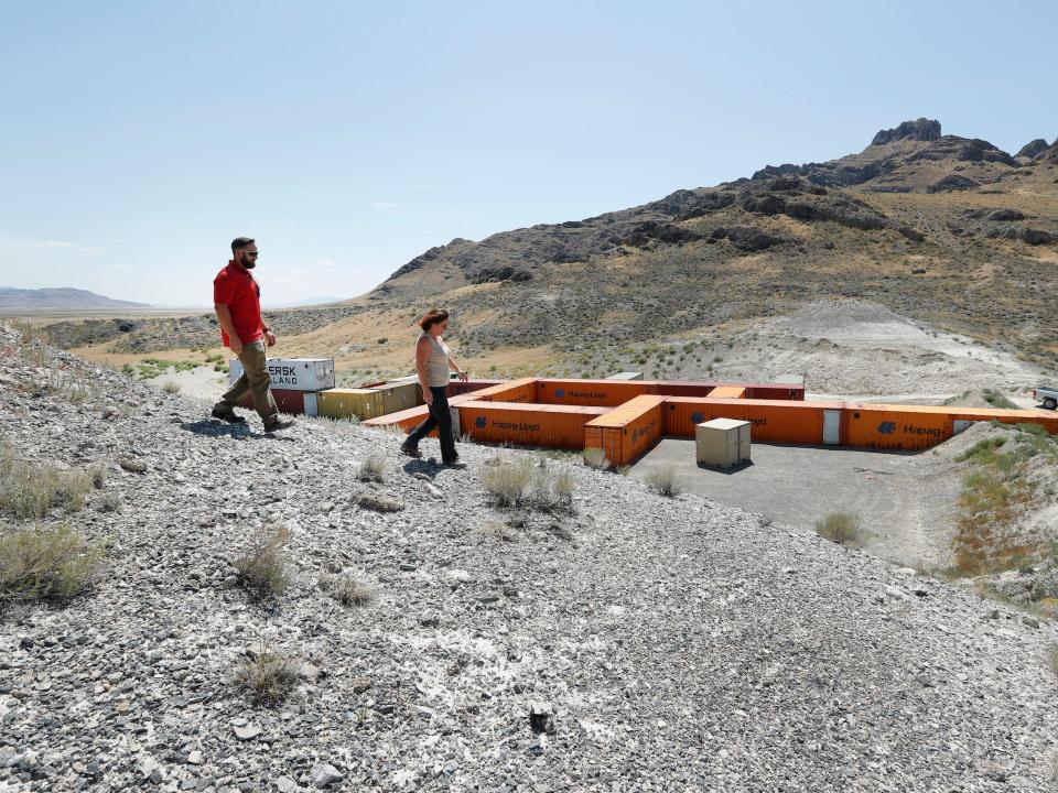 Training coordinator Jennifer Cavalli and Derek Schumann walk a hillside above a training facility at Dugway Proving Ground in 2017.