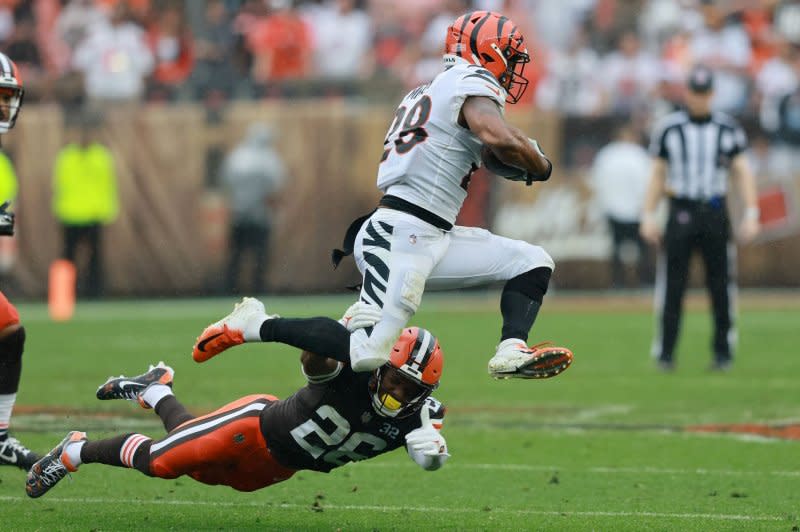 Cincinnati Bengals running back Joe Mixon (R) jumps out of the grasp of Cleveland Browns defender Rodney McLeod Jr. on Sunday in Cleveland. Photo by Aaron Josefczyk/UPI