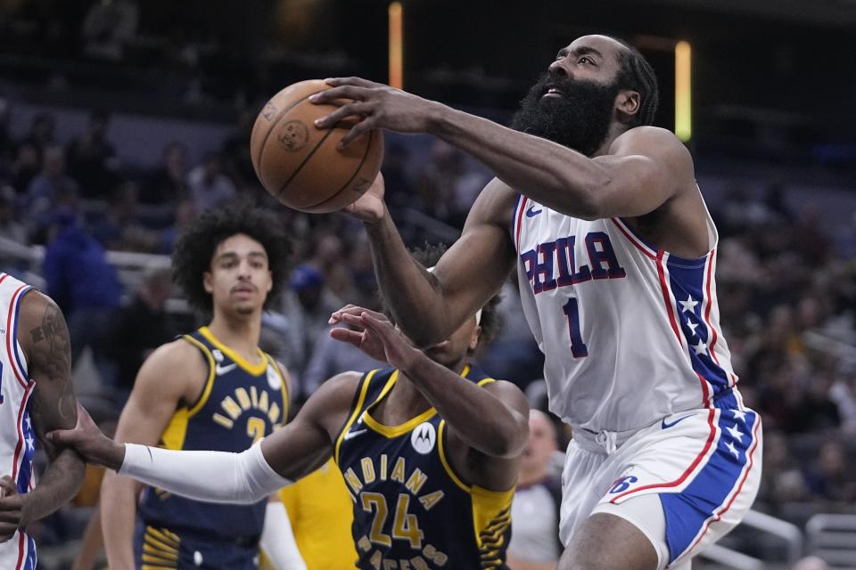 Philadelphia 76ers' James Harden (1) goes to the basket against Indiana Pacers' Buddy Hield (24) during the second half of an NBA basketball game, Monday, March 6, 2023, in Indianapolis. (AP Photo/Darron Cummings)