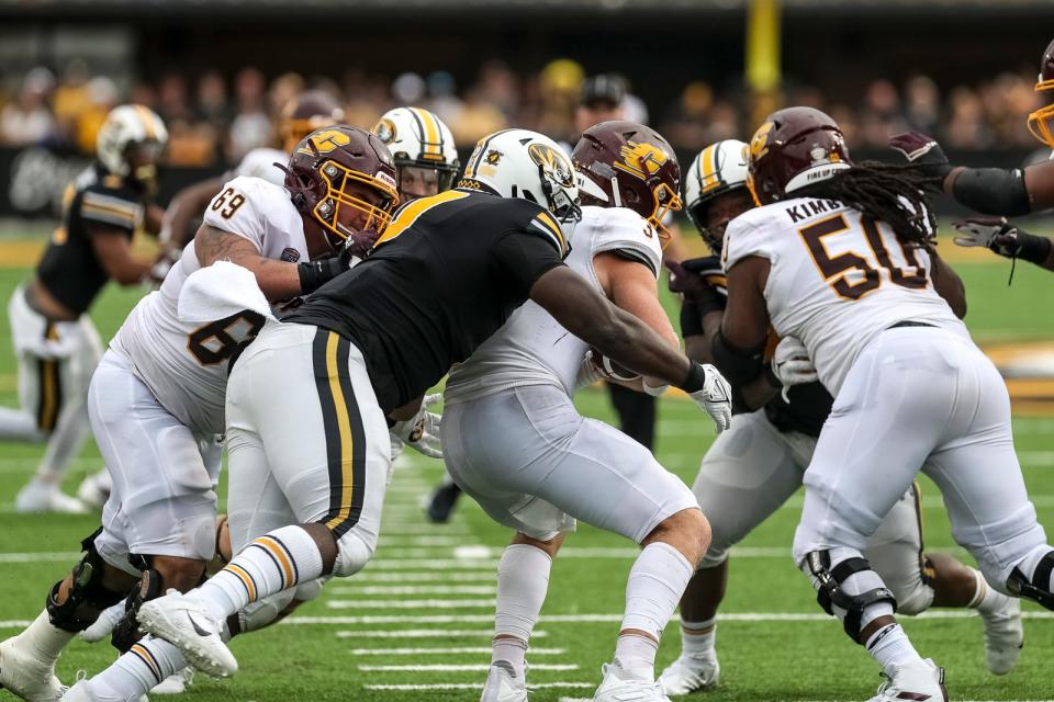 Missouri Tigers defensive lineman Akial Byers (0) sacks Central Michigan Chippewas quarterback Jacob Sirmon (3) during the Tigers' 2021 home opener.