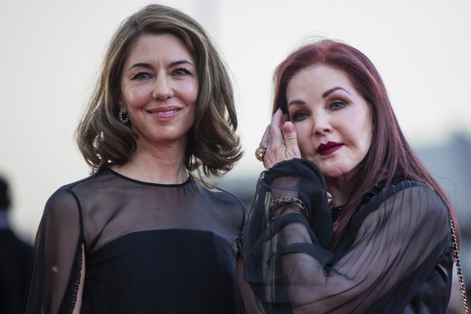 Director Sofia Coppola, left, and Priscilla Presley pose for photographers upon arrival for the premiere of the film “Priscilla” during the 80th edition of the Venice Film Festival in Venice, Italy. 