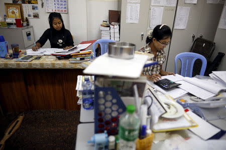 Staff members work at Ma Ba Tha's head office in Yangon August 26, 2015. Picture taken August 26. REUTERS/Soe Zeya Tun