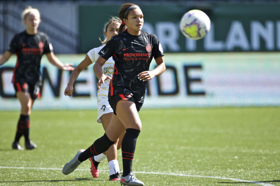 In this photo provided by the Portland Thorns, Portland Thorns' Sophia Smith chases the ball during an NWSL soccer match against Utah on Sunday, Sept. 20, 2020, in Portland, Ore. The No. 1 pick in the National Women's Soccer League draft and U.S. national team prospect, Smith comes from a family of basketball players — and it was just assumed she'd head in the same direction. Turned out Smith was right to choose soccer. It paved her way to Stanford, and now to a career in the NWSL. (Craig Mitchelldyer/Portland Thorns via AP)