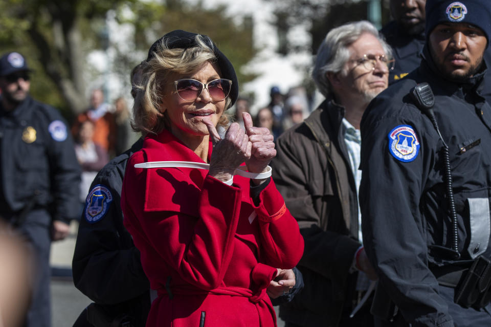 Actress Jane Fonda gestures after being arrested during a rally on Capitol Hill in Washington, Friday, Oct. 18, 2019. A half-century after throwing her attention-getting celebrity status into Vietnam War protests, Fonda is now doing the same in a U.S. climate movement where the average age is 18. (AP Photo/Manuel Balce Ceneta)