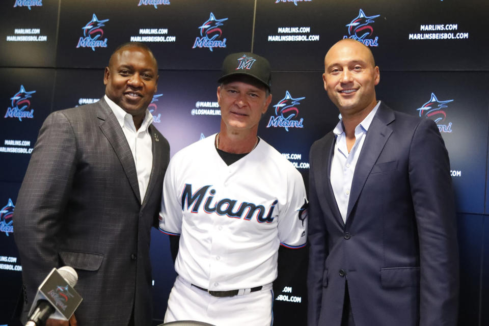 Miami Marlins manager Don Mattingly, center, poses with president of baseball operations Michael Hill, left, and CEO Derek Jeter, right, after a news conference Friday, Sept. 20, 2019, in Miami. Mattingly will be back with the Marlins in 2020. His contract extension announced Friday is for two years, plus a mutual option for a third year in 2022. (AP Photo/Wilfredo Lee)