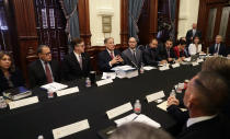 Texas Gov. Greg Abbott, top center, makes opening statements during a round table discussion, Thursday, Aug. 22, 2019, in Austin, Texas. Abbott is meeting in Austin with officials from Google, Twitter and Facebook as well as officials from the FBI and state lawmakers to discuss ways of combatting extremism in light of the recent mass shooting in El Paso that reportedly targeted Mexicans. (AP Photo/Eric Gay)