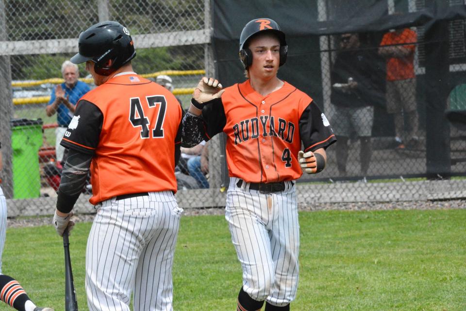 Rudyard's EJ Suggitt (47) and Aiden Bickel (4) celebrate a run during a Super Regional. Bickel received All-State honorable mention.