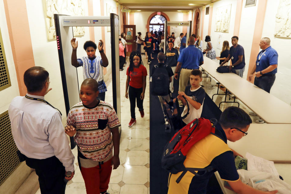 FILE - Students at William Hackett Middle School pass through metal detectors on the first day of school, on Sept. 6, 2016, in Albany, N.Y. The shooting massacre at a Texas elementary school has spurred renewed calls for school safety, but experts debate whether more heavily fortified schools are the right solution. (AP Photo/Mike Groll, File)