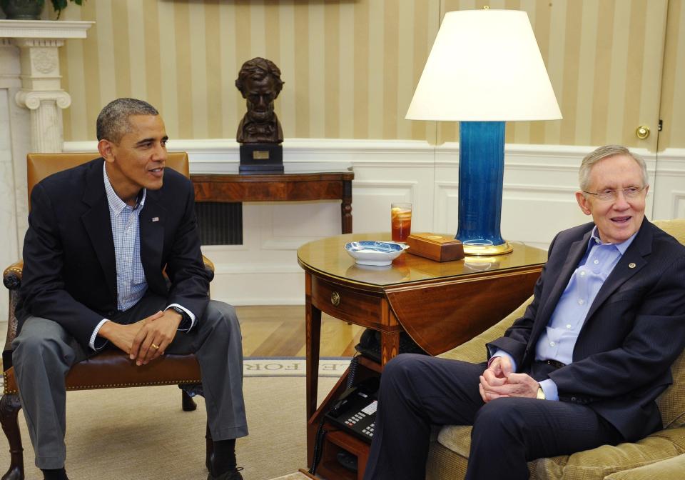 US President Barack Obama sits next to Senate Majority Leader Harry Reid, D-NV, during a meeting with Senate Democratic leadership in the Oval Office of the White House in 2013.