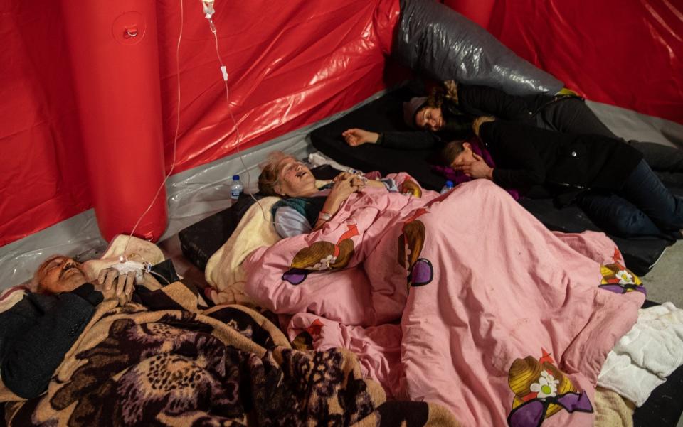 Wounded earthquake survivors wait to be treated at a field hospital in Turkey - Getty