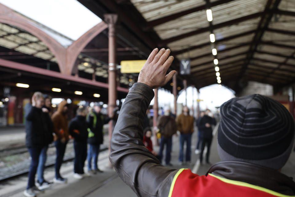 Striking railway workers vote to renew the strike Wednesday, March 8, 2023 at the Strasbourg train station, eastern France. French train and metro drivers, refinery workers, garbage collectors and others were holding further strikes on Wednesday against President Emmanuel Macron's plan to raise the retirement age to 64, in efforts to keep up pressure on the government amid the ongoing parliamentary debate. (AP Photo/Jean-Francois Badias)