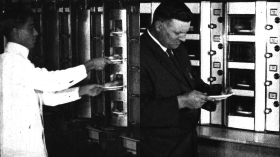 On one side of the wall, employees insert food items into rotating drums, which can be accessed on the other side by depositing coins. .  / Credit: "The Automat"