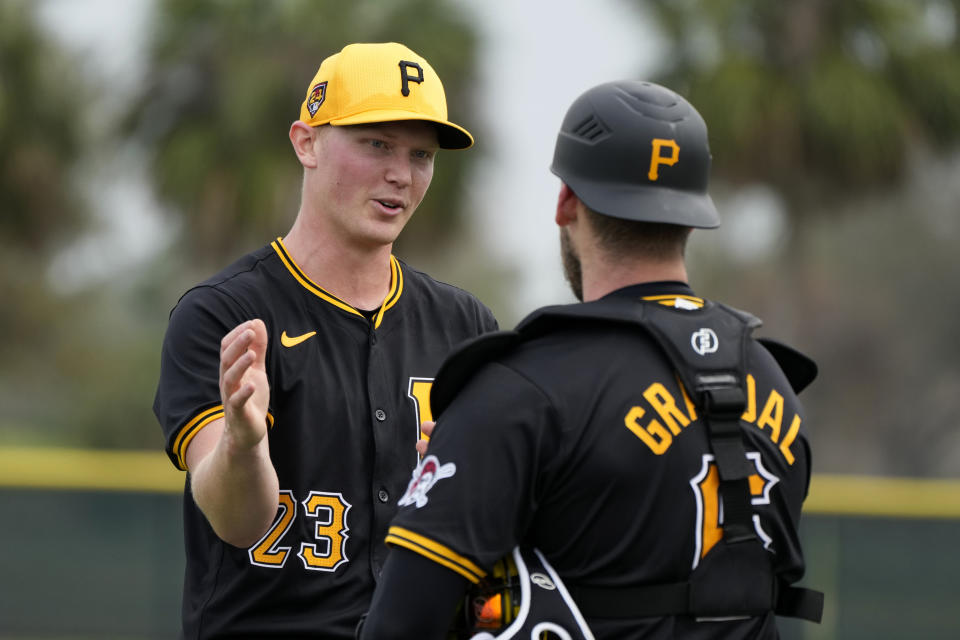 Pittsburgh Pirates starting pitcher Mitch Keller, greets catcher Yasmani Grandal during a baseball spring training workout Saturday, Feb. 17, 2024, in Bradenton, Fla. (AP Photo/Charlie Neibergall)