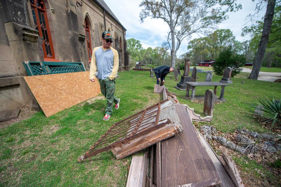 Tate Taylor, left, and Carter Burns, center, executive director of the Historic Natchez Foundation, discuss what appears to be the original finish of the pews at Christ Episcopal Church. Taylor, a church member and director of the movie "The Help", spearheads the restoration of the church, built in 1857.