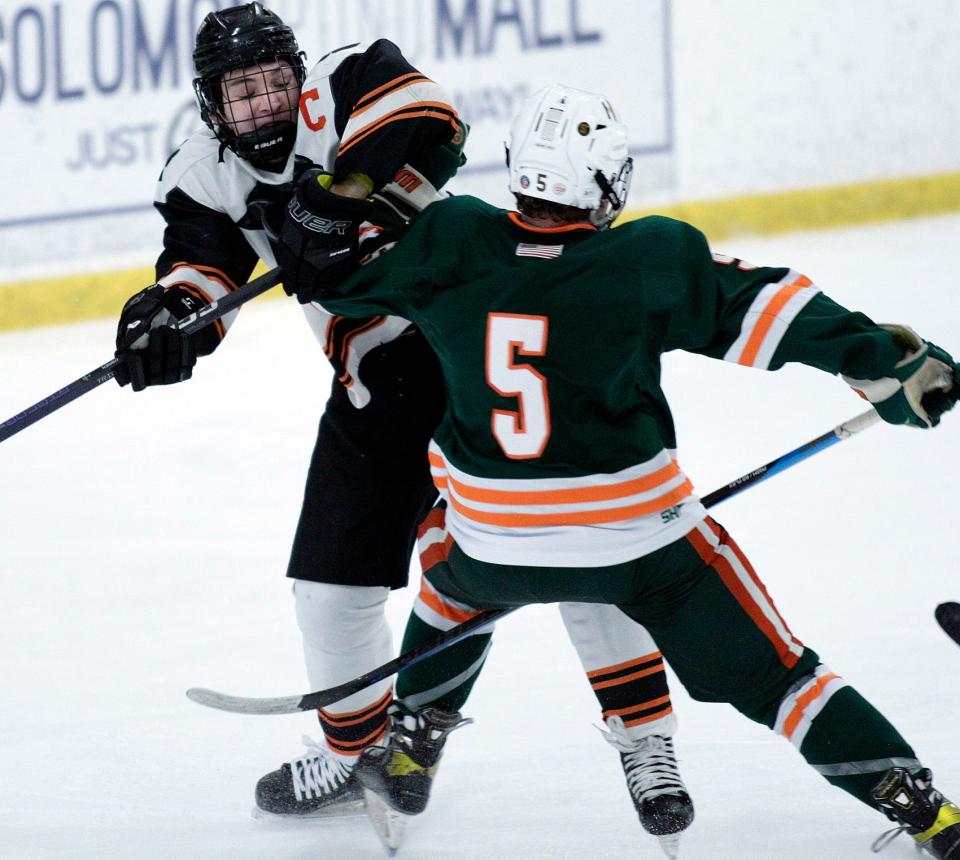 Marlborough’s Luc Masse puts a check on Hopkinton’s (5) Cory DeCosta during the Daily News Cup championships at the New England Sports Center in Marlborough.