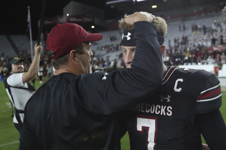 South Carolina coach Shane Beamer congratulates quarterback Spencer Rattler (7) after after the team's win in an NCAA college football game against Kentucky on Saturday, Nov. 18, 2023, in Columbia, S.C. (AP Photo/Artie Walker Jr.)
