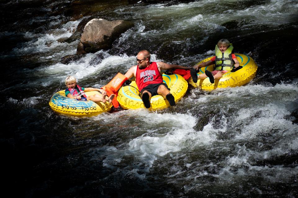 People ride their tubes down the Little River at the Townsend Wye in the Great Smoky Mountains National Park on July 11.