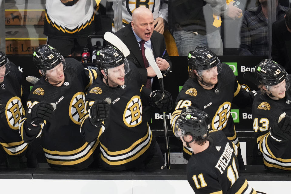 Boston Bruins head coach Jim Montgomery cheers after a goal by center Trent Frederic (11) during the first period of Game 5 of an NHL hockey Stanley Cup first-round playoff series agains the Toronto Maple Leafs, Tuesday, April 30, 2024, in Boston. (AP Photo/Charles Krupa)