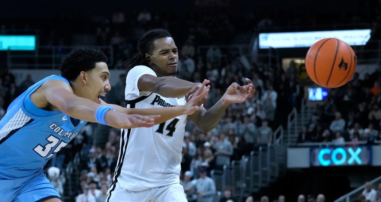 Columbia defender Noah Robledo reaches but doesn't stop Friars guard Corey Floyd Jr. from shuffling off a pass in the first half of the season-opener on Monday.