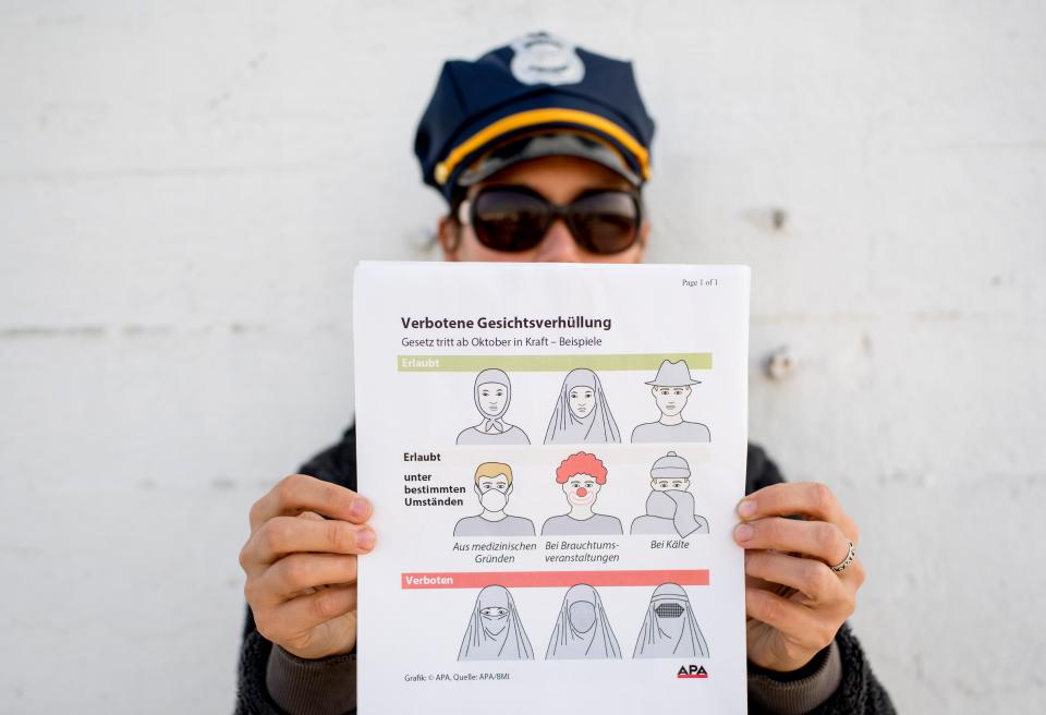 An information pamphlet shows the new Austrian restrictions banning the wearing of burqas and other items covering the face in public places and buildings (Getty Images)