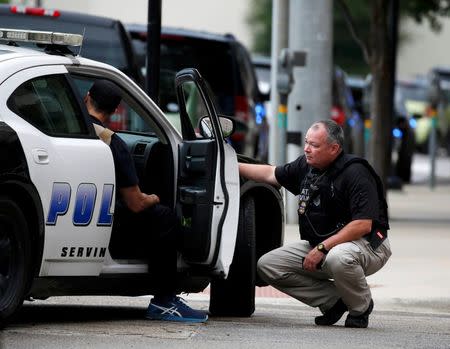 Dallas police officers in front of the Dallas Police Department headquarters after an anonymous threat was reported in Dallas, Texas, U.S. July 9, 2016. REUTERS/Carlo Allegri