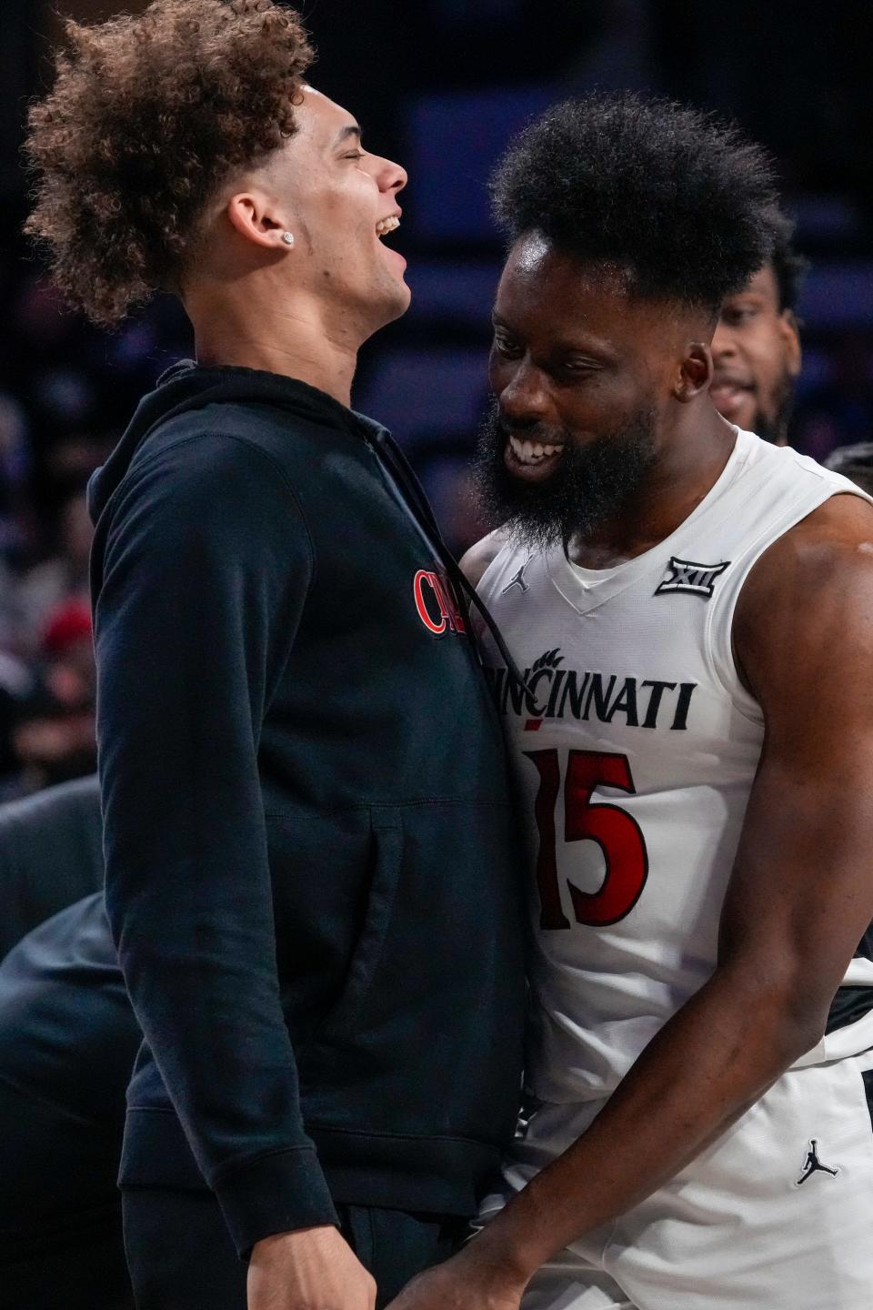 Cincinnati Bearcats guard Dan Skillings Jr. (0) chest bumps forward John Newman III (15) during UC's 74-72 victory over Kansas State Saturday night. Skillings was unavailable to play with a hip issue.