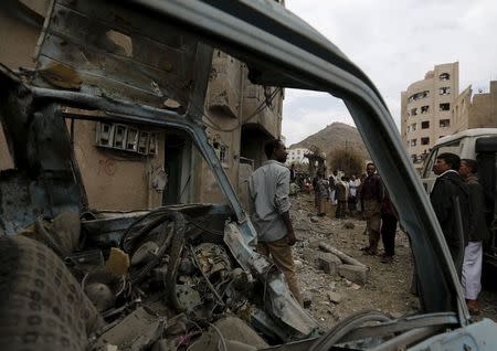 People gather at the site of a Saudi-led air strike in Yemen's capital Sanaa August 30, 2015.REUTERS/Khaled Abdullah