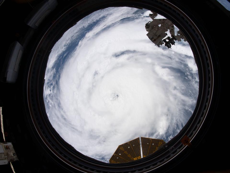 hurricane ida cyclone seen through a window port on the space station